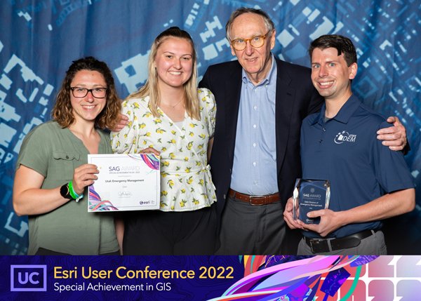(L-R) Julia Surkis, Emma McFee, Esri President Jack Dangermond, and Josh Groeneveld pose for a picture following the presentation of the Special Achievement in GIS award at the 2022 Esri National Conference in San Diego, July 2022